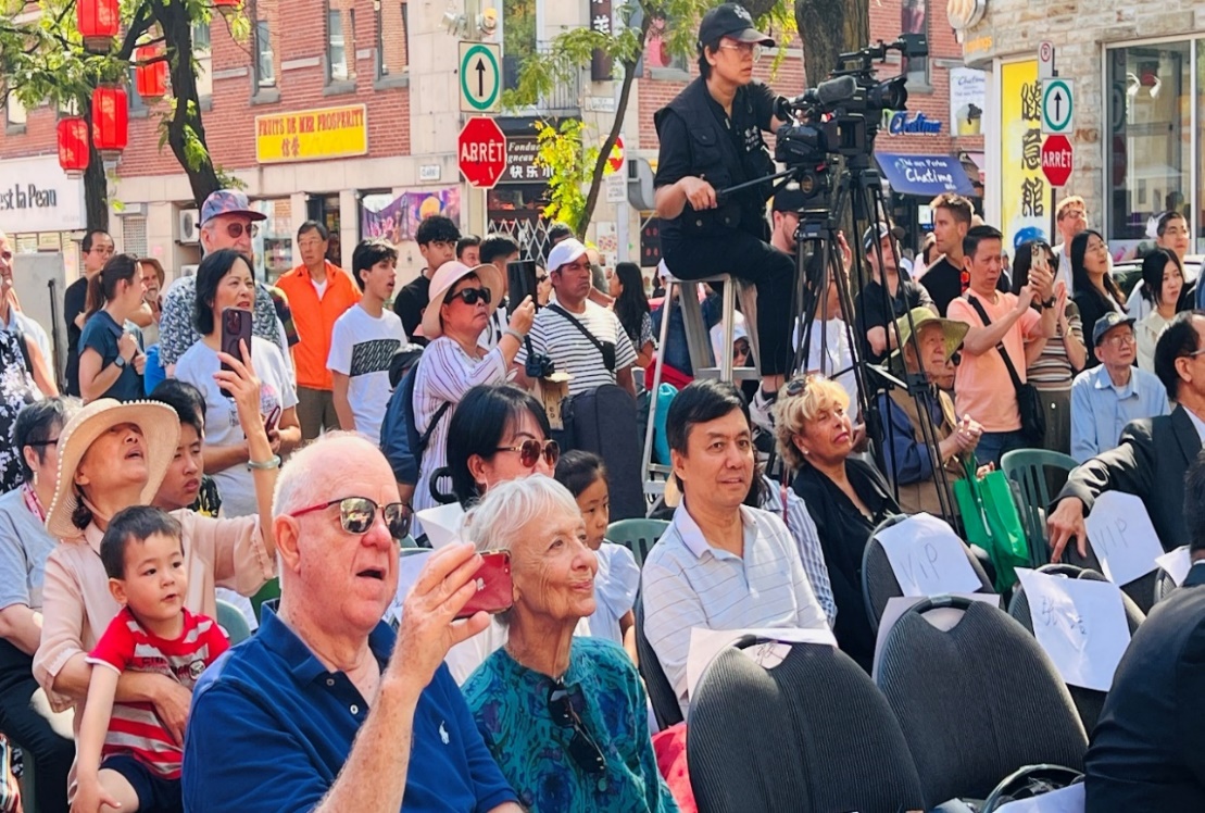 A group of people sitting in a crowd Description automatically generated